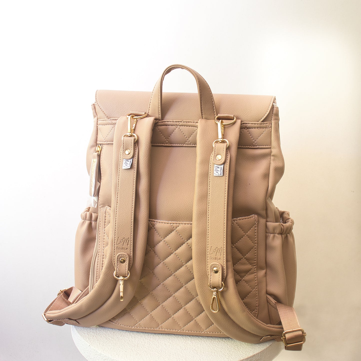 beige diaper bag with pram clips