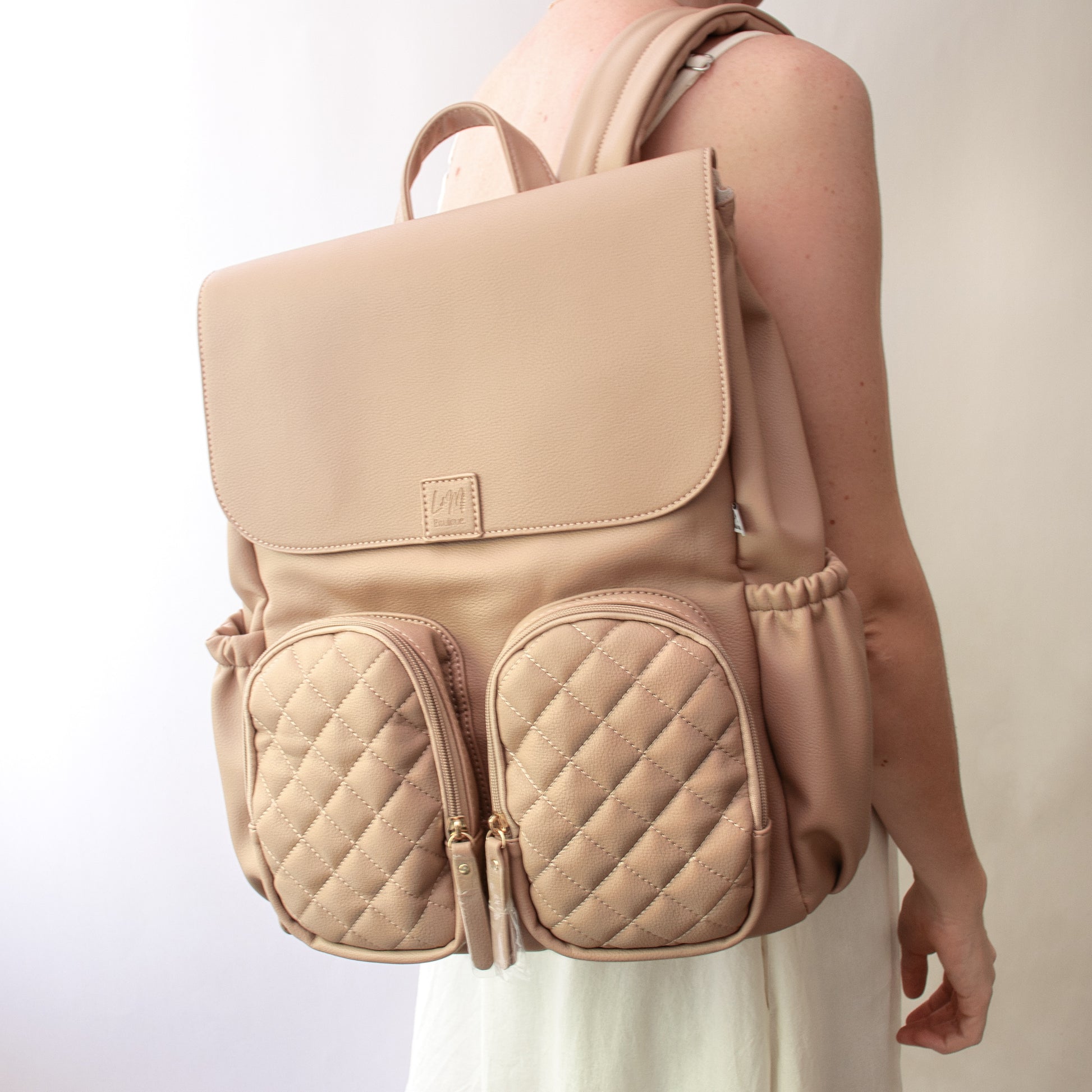 beige baby backpack with quilted design nappy bag
