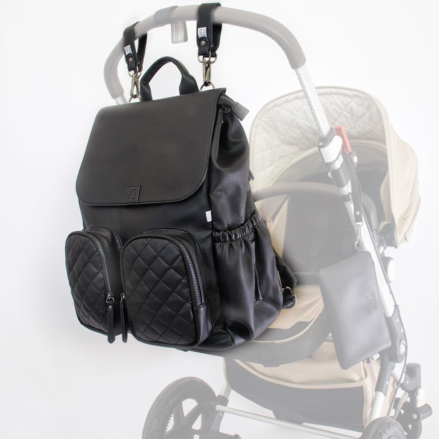 Milana Baby Nappy Bag in Matte Black by L&M Boutique attached to the pram for hands-free use